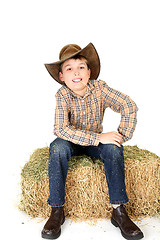 Image showing Boy chewing on a piece of straw