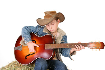 Image showing Boy strumming guitar