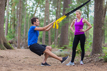 Image showing Training with fitness straps outdoors.