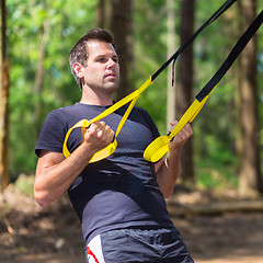 Image showing Training with fitness straps outdoors.