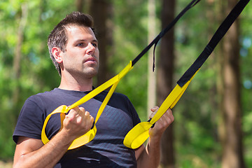 Image showing Training with fitness straps outdoors.