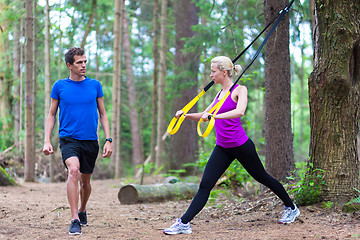 Image showing Training with fitness straps outdoors.