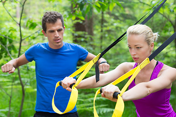 Image showing Training with fitness straps outdoors.