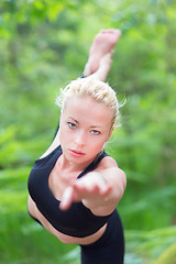 Image showing Woman practicing yoga in the nature.