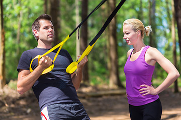 Image showing Training with fitness straps outdoors.