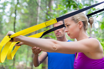 Image showing Training with fitness straps outdoors.