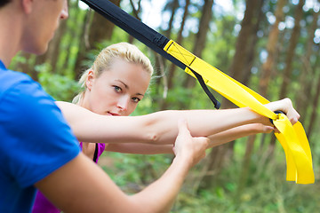 Image showing Training with fitness straps outdoors.