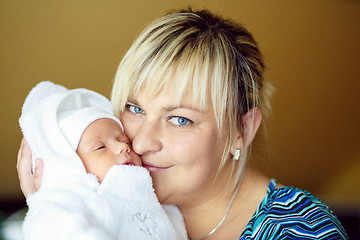 Image showing Loving mother embracing her baby