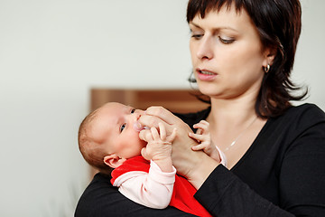 Image showing Loving mother embracing her baby