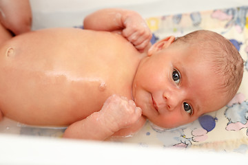 Image showing take a bath for a young adorable baby