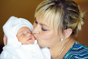 Image showing Loving mother embracing her baby