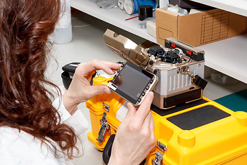 Image showing woman working with fiber optic fusion splicer