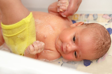 Image showing take a bath for a young adorable baby