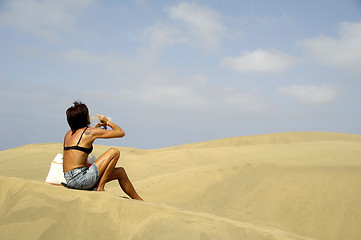 Image showing Woman drinking in desert