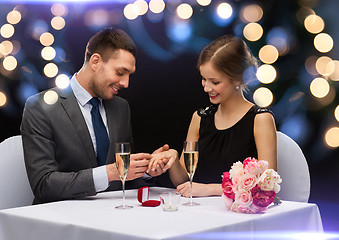 Image showing man proposing to his girlfriend at restaurant