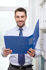 Image showing businessman with folder at office
