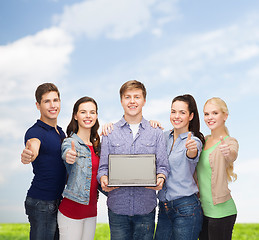 Image showing smiling students with laptop computer