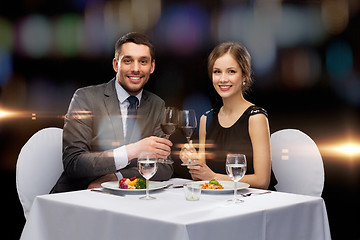 Image showing smiling couple eating main course at restaurant