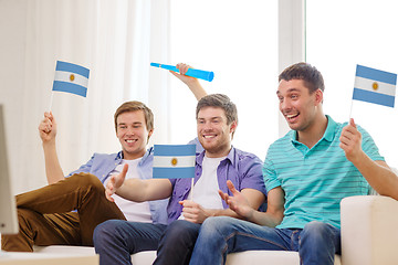 Image showing happy male friends with flags and vuvuzela