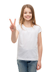 Image showing little girl in white t-shirt showing peace gesture