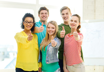 Image showing five smiling showing thumbs up at school