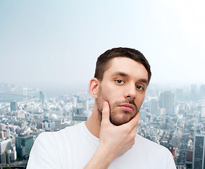 Image showing beautiful calm man touching his face