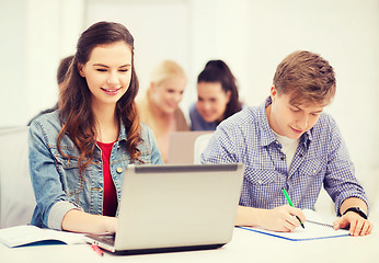 Image showing students with laptop and notebooks at school