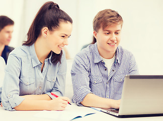 Image showing students with laptop and notebooks at school