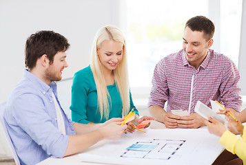 Image showing smiling interior designers working in office