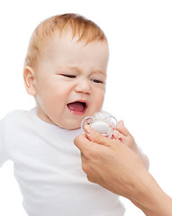 Image showing crying baby with dummy