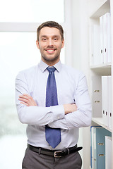 Image showing handsome businessman with crossed arms at office