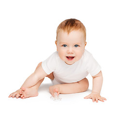 Image showing smiling baby sitting on the floor