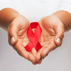 Image showing hands holding red AIDS awareness ribbon