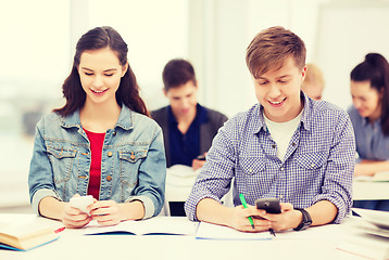 Image showing students looking into smartphone at school