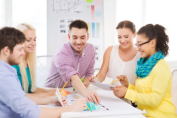 Image showing smiling interior designers working in office