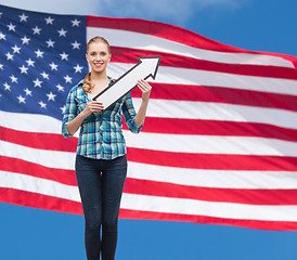 Image showing smiling young woman with arrow poiting up