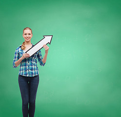 Image showing smiling young woman with arrow poiting up