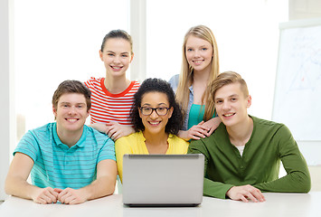 Image showing smiling students with laptop at school