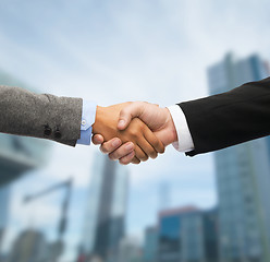 Image showing businessman and businesswoman shaking hands