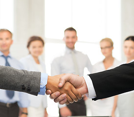 Image showing businessman and businesswoman shaking hands