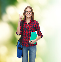 Image showing smiling female student with bag and notebooks