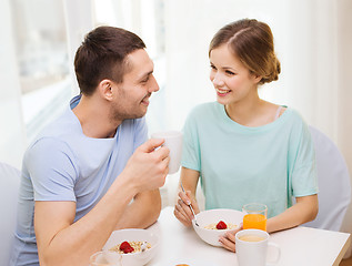 Image showing smiling couple having breakfast at home