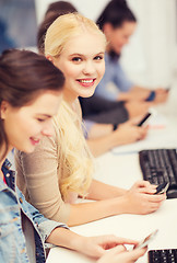 Image showing students with computer monitor and smartphones