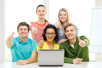 Image showing smiling students with laptop at school