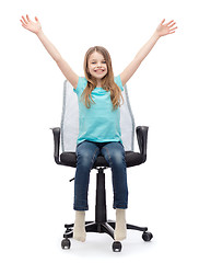 Image showing smiling little girl sitting in big office chair