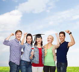 Image showing group of standing smiling students with diploma