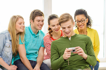 Image showing smiling students with digital camera at school