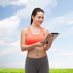 Image showing sporty woman with tablet pc computer