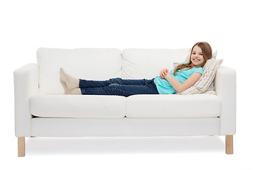 Image showing smiling little girl lying on sofa
