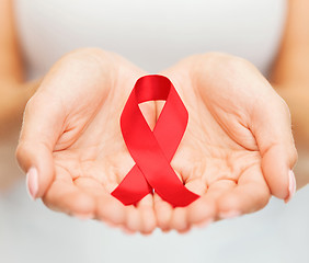 Image showing hands holding red AIDS awareness ribbon